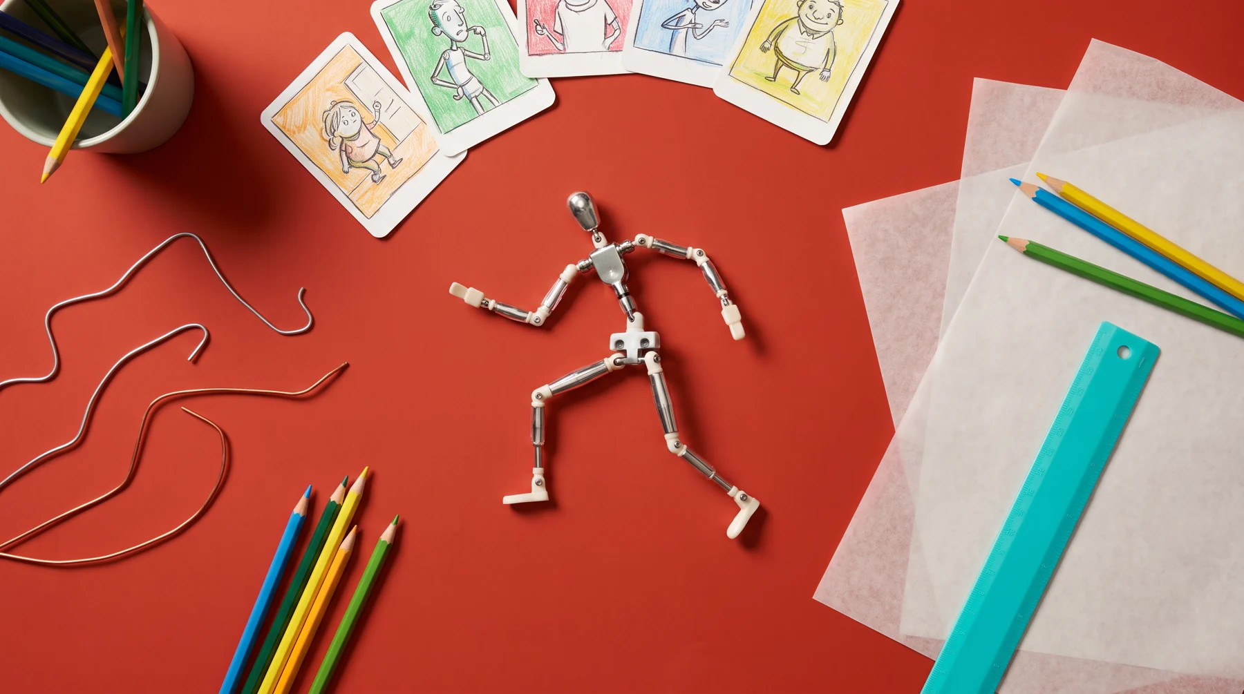 Animation armature and pose studies on a red table